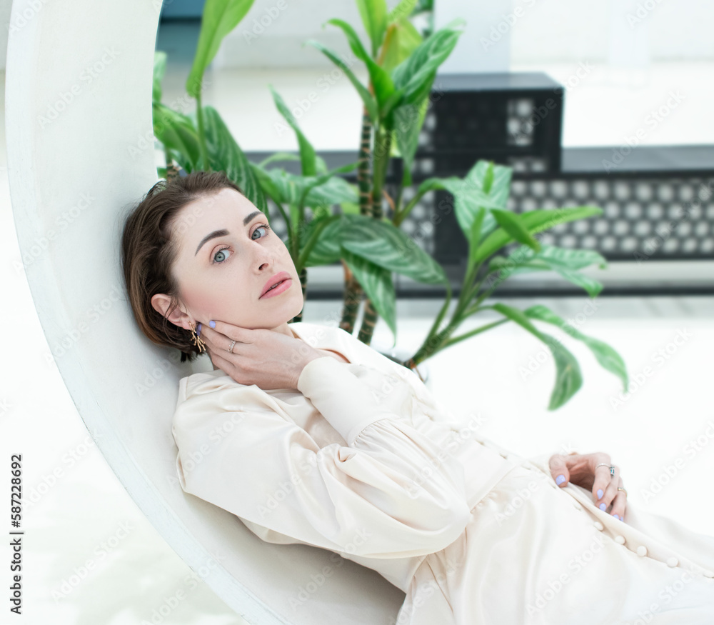 Young graceful woman closeup on the brick white wall Young graceful woman closeup on the brick white wall