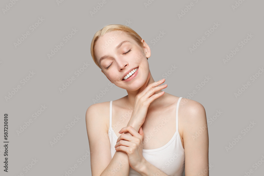 Skin care concept. Beautiful young healthy blonde woman with clear shiny skin relaxing and smiling, portrait. Skin care concept. Beautiful young healthy blonde woman with clear shiny skin relaxing and smiling, portrait.