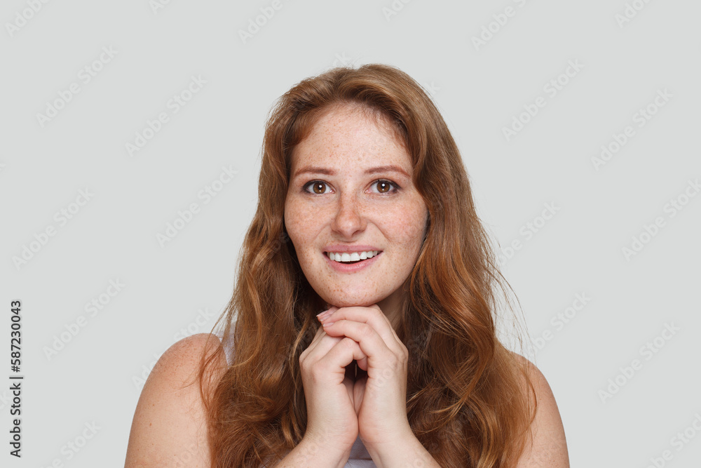 Natural beauty. Perfect real redhead woman with clean shiny healthy skin with freckles smiling on white studio wall background Natural beauty. Perfect real redhead woman with clean shiny healthy skin with freckles smiling on white studio wall background