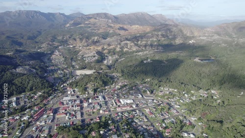 Queenstown In Tasmania - Small Mining Town With Natural Scenery Of Rugged Mountain On A Sunny Day. wide aerial photo