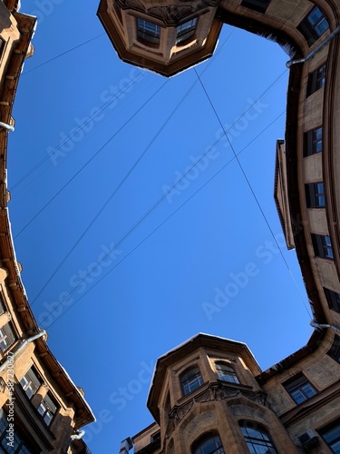 View from below on the blue sky, the courtyard-well of the original form, located in the center of St. Petersburg.