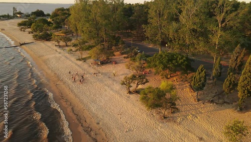 Aerial Drone View of Family Walking on the Beach in Uruguay - Slowmotion photo