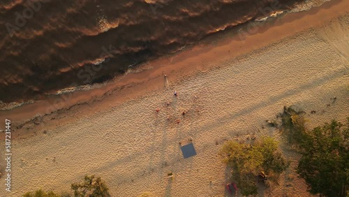 Drone View of People Playing At Beach In Uruguay, Playa Grande Beach - Top Down View Circling photo