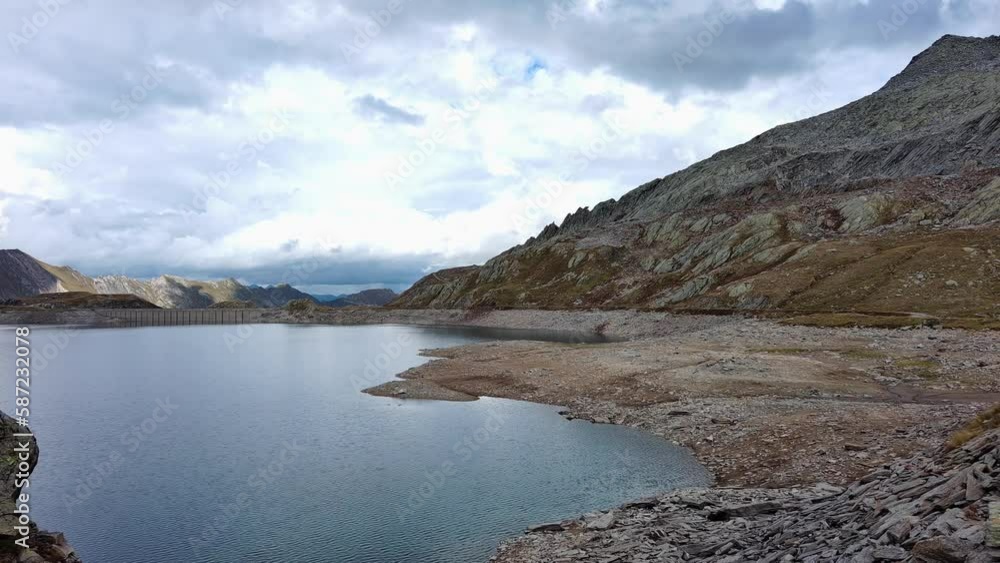 Lago del Naret - Serene Alpine Lake In Ticino, Switzerland Surrounded By Majestic Mountains. drone pullback Lago del Naret - Serene Alpine Lake In Ticino, Switzerland Surrounded By Majestic Mountains. drone pullback