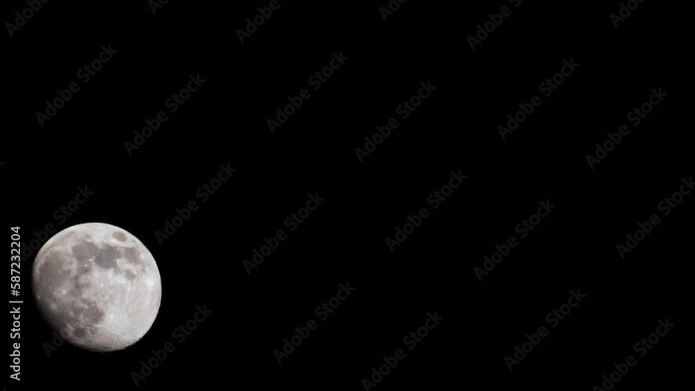 night timelapse of the moon drifting across sky behind branches night timelapse of the moon drifting across sky behind branches