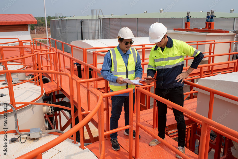 Worker under checking the waste water treatment pond industry large to