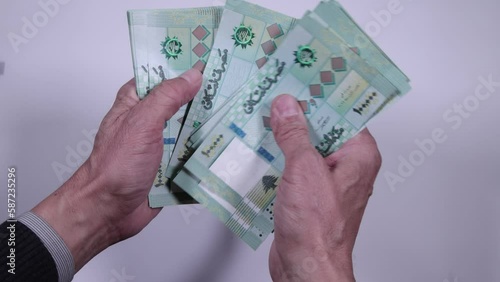 Hands counting Lebanese lira or pound banknotes photo