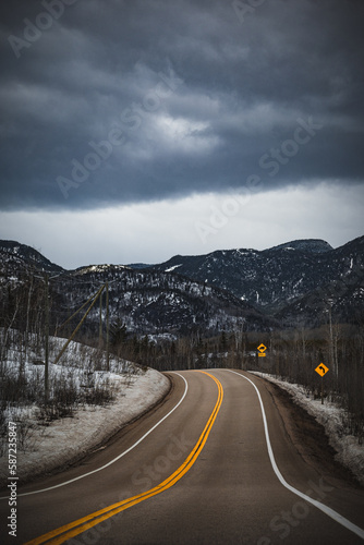 Vertical shot of an asphalt road in a mountainous background in Ile Perrot, Quebec, Canada photo