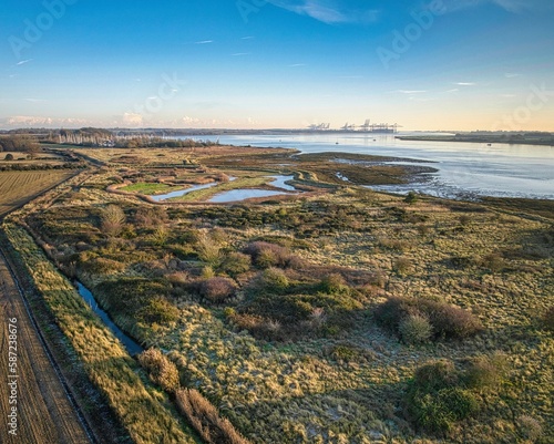 Aerial view of the Orwell river with Levington Marina and the Felixstowe port cranes in the distance