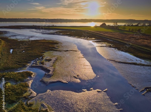 Aerial view of the Levington Creek on the Orwell river at sunset in Suffolk, England © Ronnies-creatives/Wirestock Creators