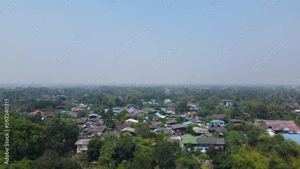 Revealing Shot of a Thai Village from the Mae Klong River in Ratchaburi, Thailand with an Aerial Drone Dolly Shot in 4K. Revealing Shot of a Thai Village from the Mae Klong River in Ratchaburi, Thailand with an Aerial Drone Dolly Shot in 4K.