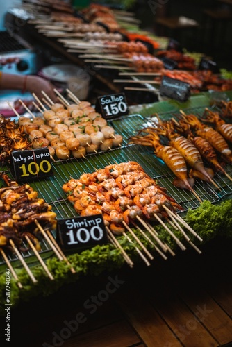 Closeup of several food items on a grill at a market