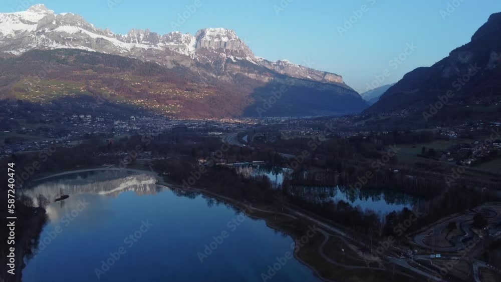 Flying towards the city of Sallanches and over the Passy lake that shows mountains reflections. French Alps Flying towards the city of Sallanches and over the Passy lake that shows mountains reflections. French Alps