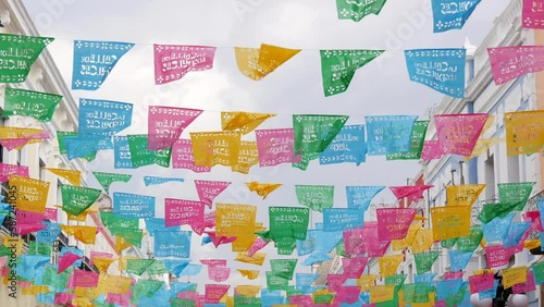 Colorful mexican perforated papel picado banner, festival colourful paper garland. Multi colored hispanic folk carved tissue flags, holiday or carnival. Authentic fiesta decoration in Latin America.