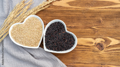 Brown rice and rice berry on a wooden table.