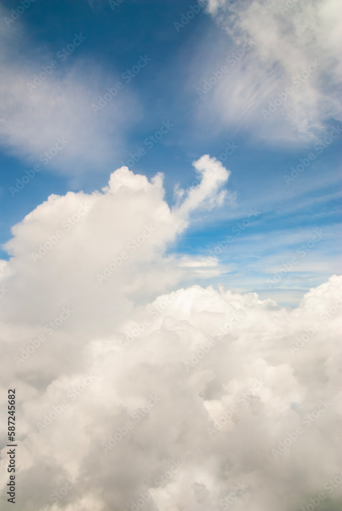 Fluffy clouds. Beautiful dramatic sunset sky above fluffy clouds in early morning from aerial drone view. Traveling by air. View from an airplane window. Aerial view of Malaysia.White clouds floating Fluffy clouds. Beautiful dramatic sunset sky above fluffy clouds in early morning from aerial drone view. Traveling by air. View from an airplane window. Aerial view of Malaysia.White clouds floating