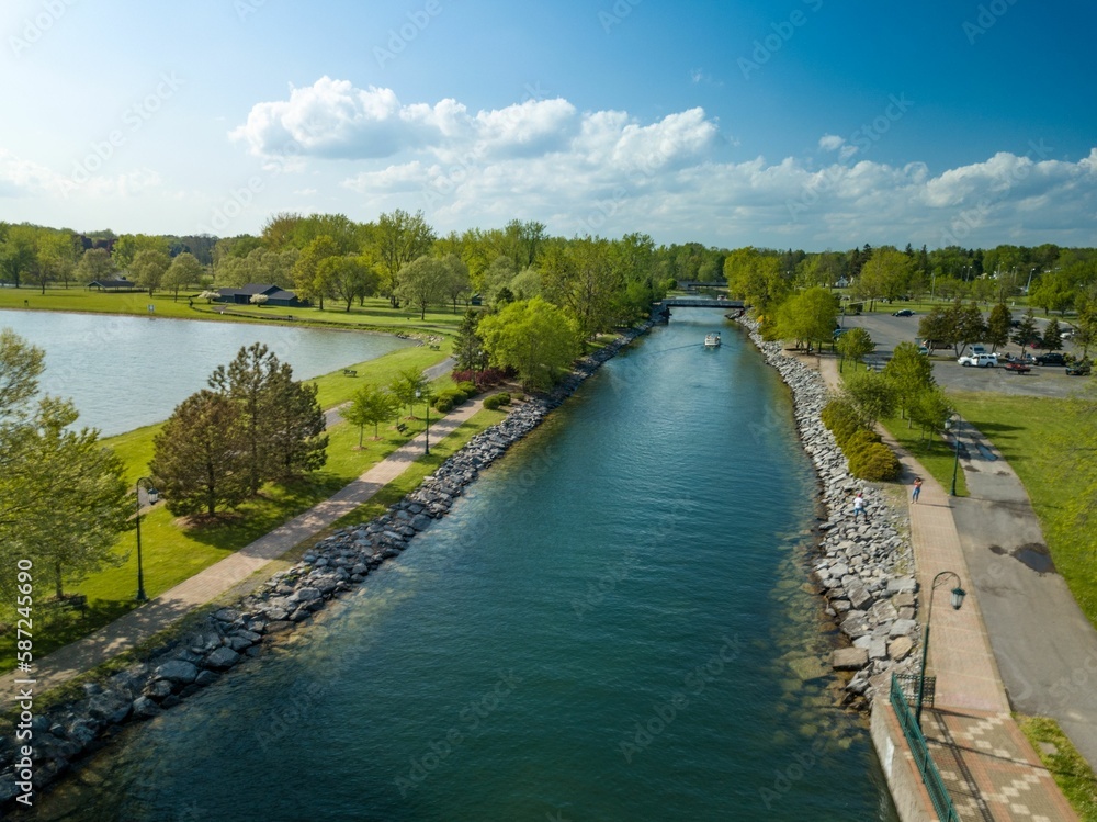 Aerial view of the river and greenery of Emerson park before the blue skyline