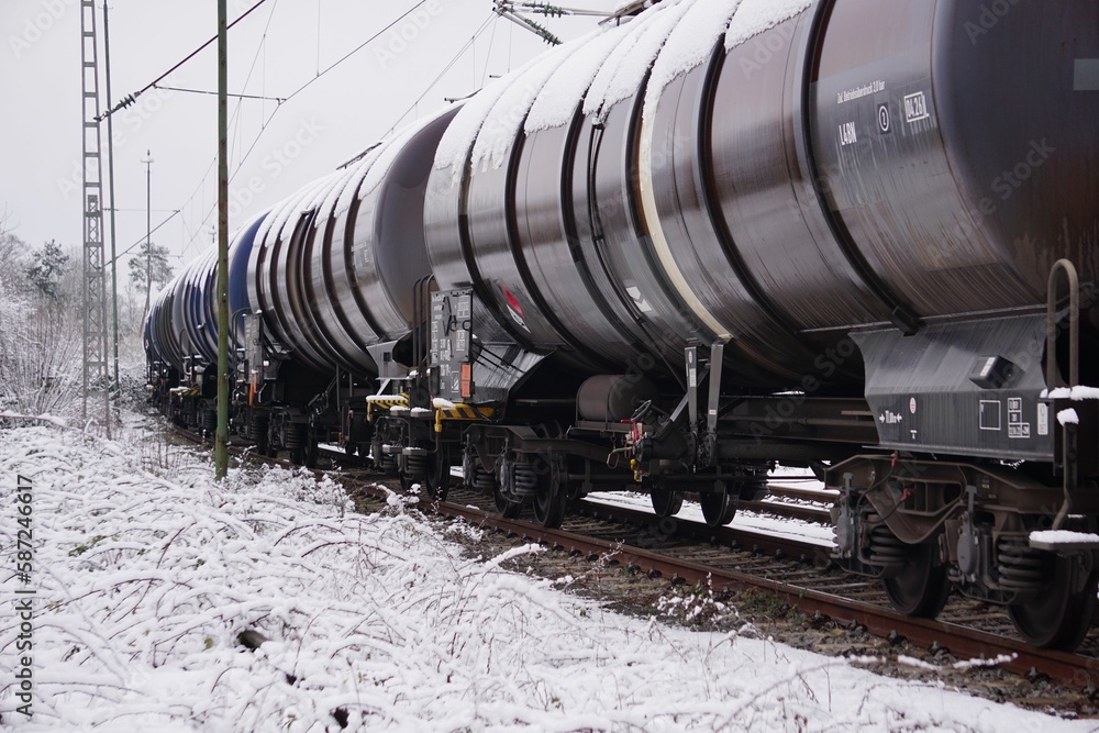 View of tanks carrying oil in the winter by rail in the forest View of tanks carrying oil in the winter by rail in the forest