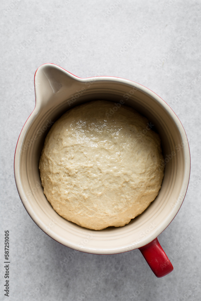 Dough that has doubled in size, dough that has risen, proofed dough in a bowl Dough that has doubled in size, dough that has risen, proofed dough in a bowl
