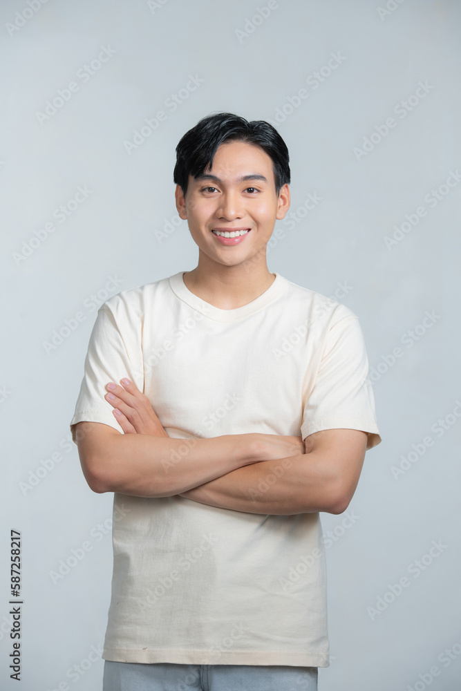 Portrait of young smiling asian man with crossed arms, isolated on white Portrait of young smiling asian man with crossed arms, isolated on white