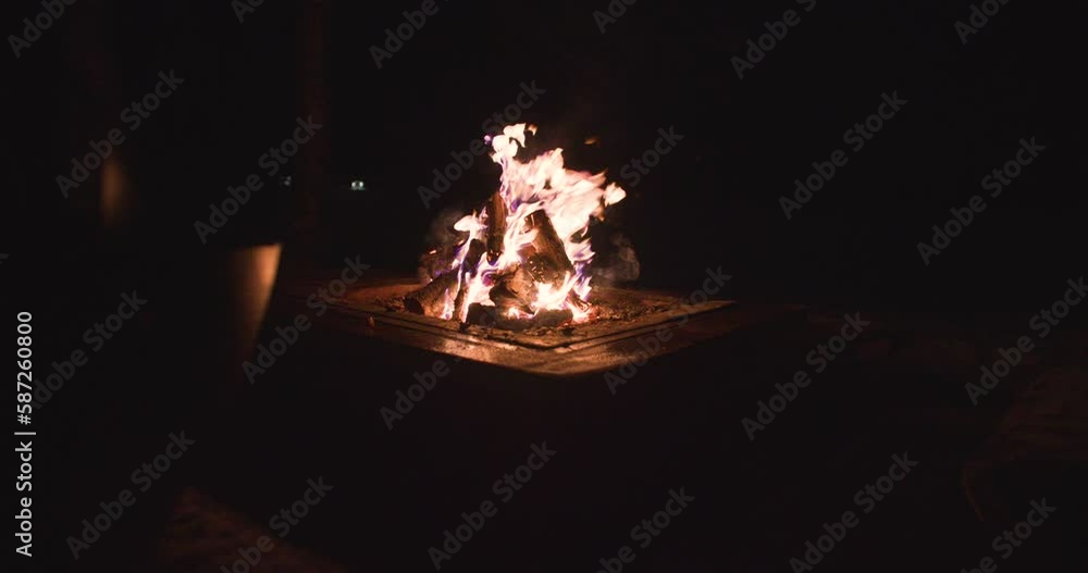 Handheld shot of blazing outdoor fire pit in Norbotten, Lapland great outdoors at night Handheld shot of blazing outdoor fire pit in Norbotten, Lapland great outdoors at night