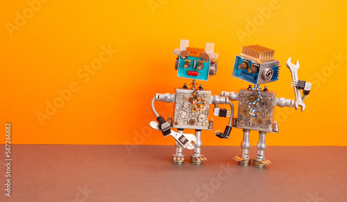 Two handyman mechanic robots with adjustable wrench, hand wrench tools on orange brown background. Maintenance fixing service concept.