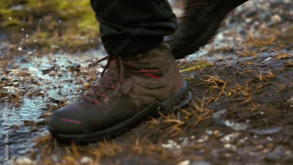 Closeup of a person's boots walking on the muddy grass. slow motion Closeup of a person's boots walking on the muddy grass. slow motion