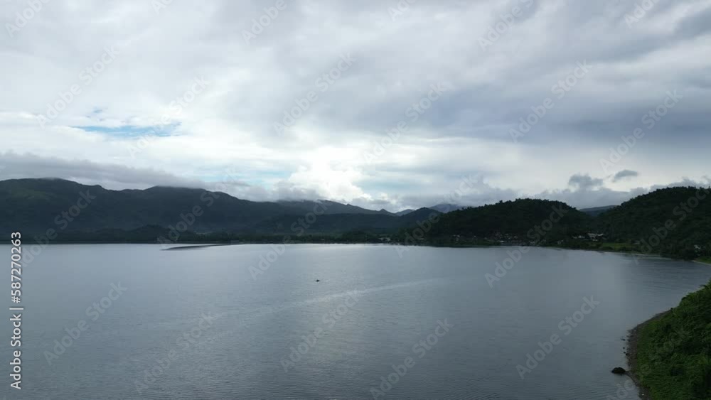 Breathtaking Aerial View of wide ocean bay with lush island mountains and dramatic clouds in background. Breathtaking Aerial View of wide ocean bay with lush island mountains and dramatic clouds in background.