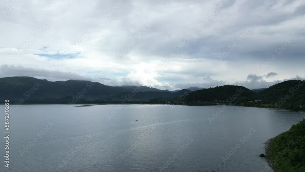 Aerial View of gloomy island bay with dramatic cloudscape and calm ocean waters during a rainy day. Aerial View of gloomy island bay with dramatic cloudscape and calm ocean waters during a rainy day.
