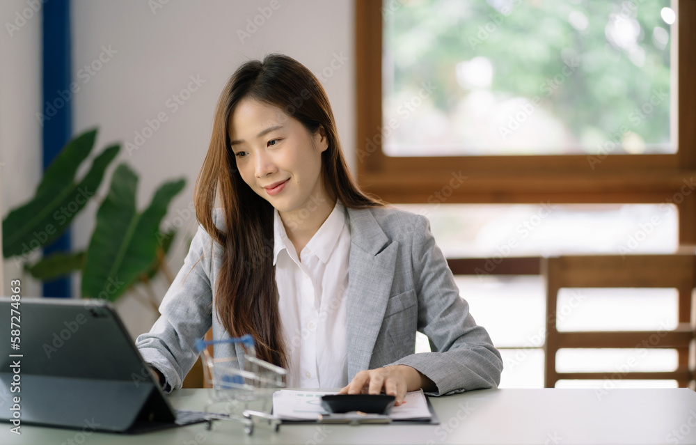 Female businessman working with calculator, business document and laptop computer notebook at home office. Female businessman working with calculator, business document and laptop computer notebook at home office.