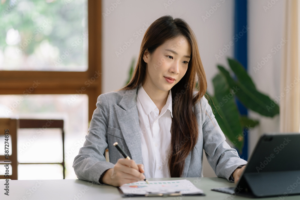 Female writes information businessman working on laptop computer writing business plan while sitting in home office. Female writes information businessman working on laptop computer writing business plan while sitting in home office.