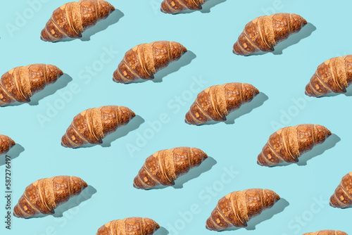 Wallpaper Mural Fresh tasty croissants, creative food pattern against light blue background.  Torontodigital.ca