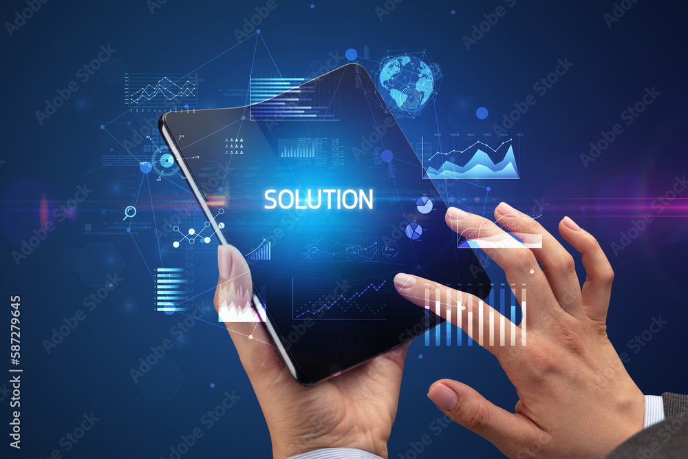 Businessman holding a foldable smartphone, business concept Businessman holding a foldable smartphone, business concept