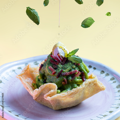 olio extravergine di oliva su spaghetto al pesto di piselli e pistacchi con speck e ricotta fresca photo