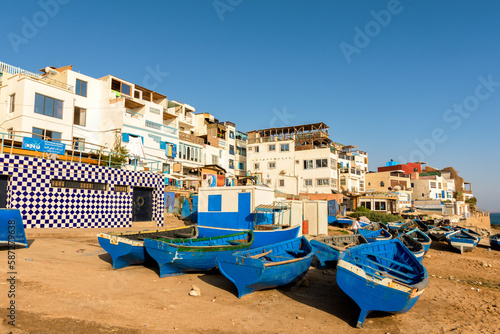 Blue wooden boats on the shore in Taghazout Village in Morocco