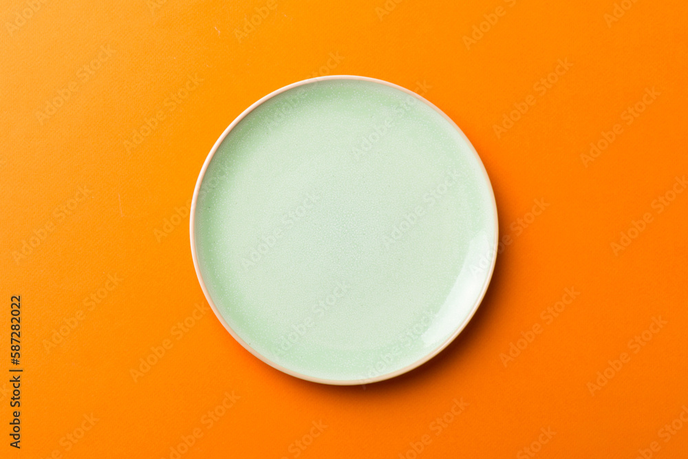 Top view of isolated of colored background empty round green plate for food. Empty dish with space for your design Top view of isolated of colored background empty round green plate for food. Empty dish with space for your design