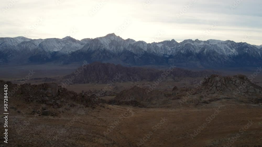 Aerial Shot Of Tranquil Snow Covered Rock Formations Against Sky, Drone Flying Forward Over Landscape During Sunset - Alabama Hills, California Aerial Shot Of Tranquil Snow Covered Rock Formations Against Sky, Drone Flying Forward Over Landscape During Sunset - Alabama Hills, California