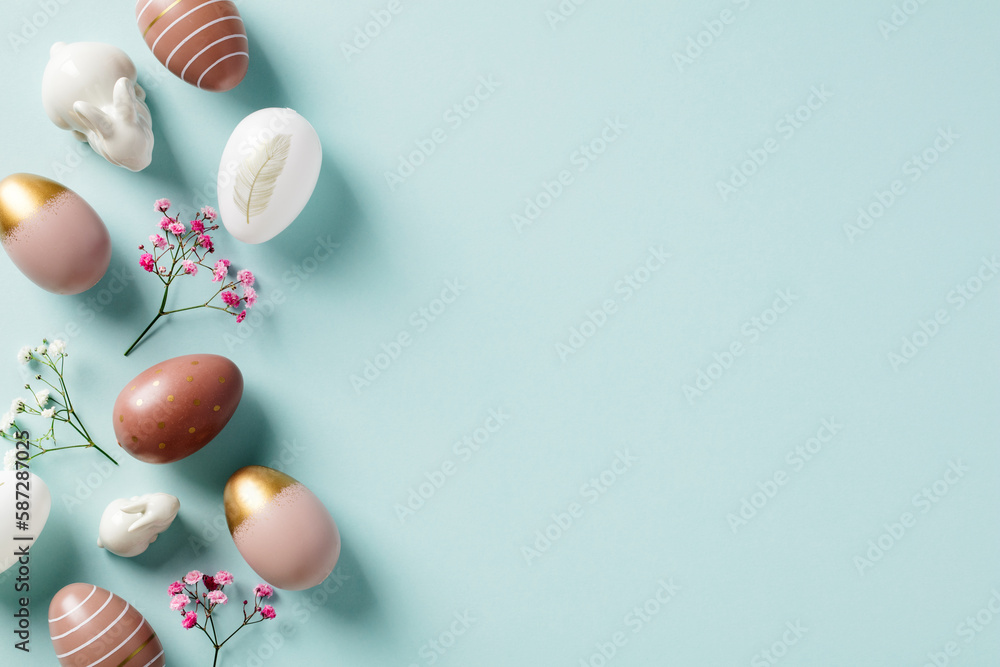 Happy Easter frame border made of Easter eggs, rabbits, flowers on pastel blue background. Flat lay, top view. Easter background. Happy Easter frame border made of Easter eggs, rabbits, flowers on pastel blue background. Flat lay, top view. Easter background.