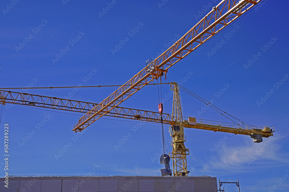 Lattice boom crane in use on a large construction site