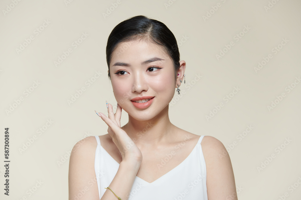 Beautiful young woman with clean fresh skin touching her face Beautiful young woman with clean fresh skin touching her face