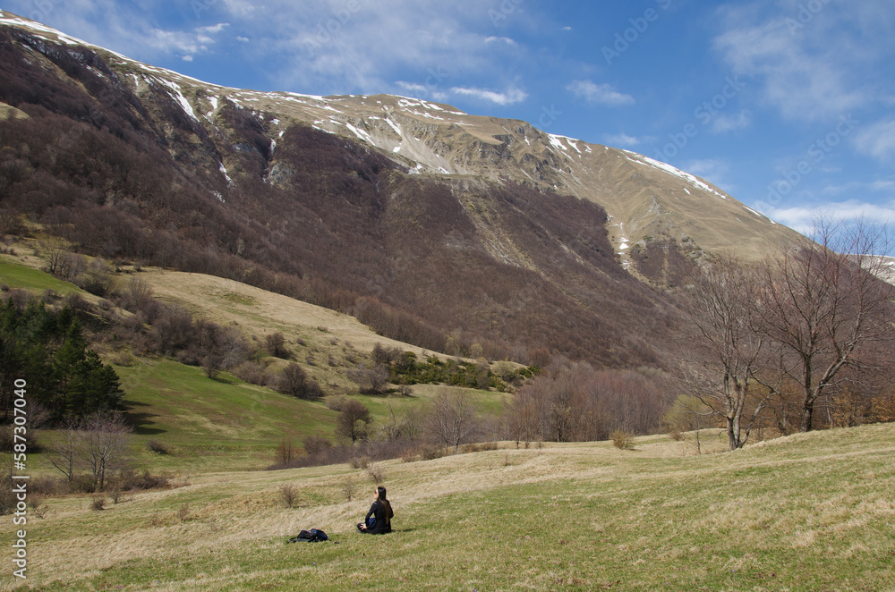 Woman practicing yoga in the beautiful italian mountain during spring season, Marche region