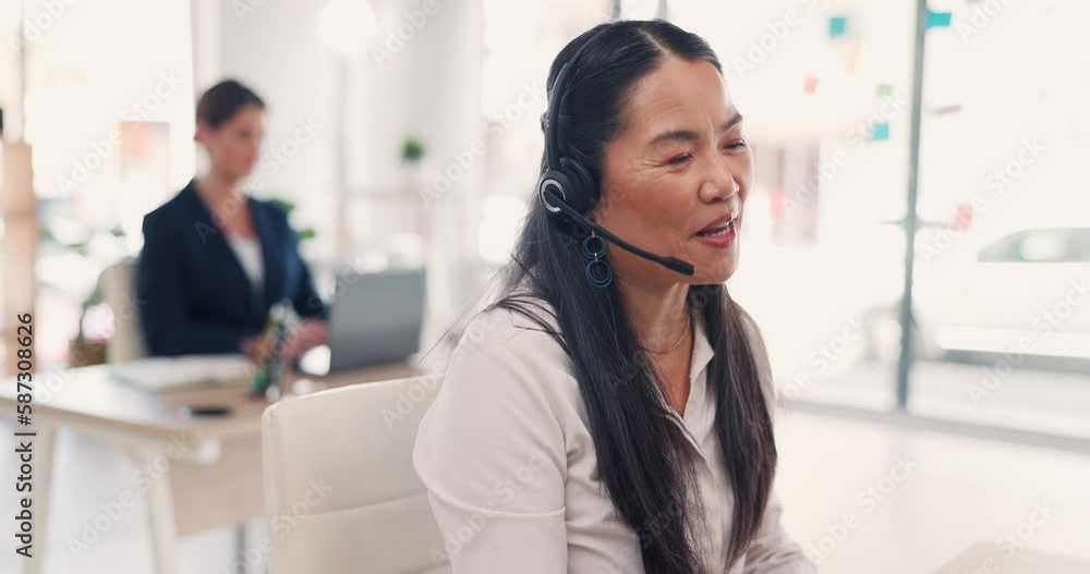 Asian woman, call center and consulting on computer in customer service, telemarketing or support at office. Female consultant agent talking with headphones to client for online advice or help on PC