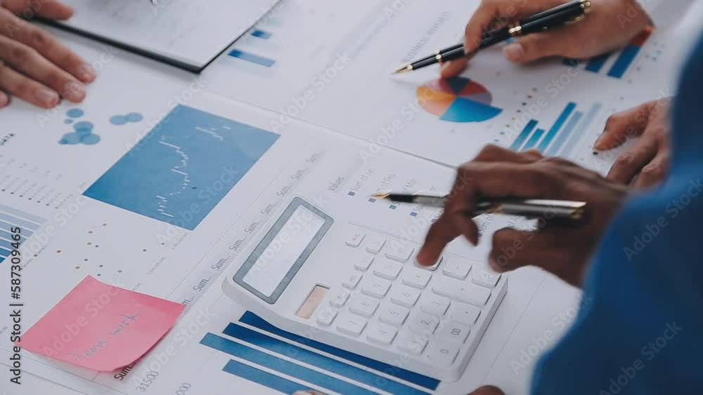 Group of confident business people point to graphs and charts to analyze market data, balance sheet, account, net profit to plan new sales strategies to increase production capacity. Group of confident business people point to graphs and charts to analyze market data, balance sheet, account, net profit to plan new sales strategies to increase production capacity.