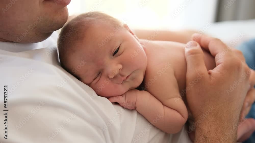 Adorable newborn baby lying at his father cheast and falling asleep. Beautiful moments of man parent and his infant child together Adorable newborn baby lying at his father cheast and falling asleep. Beautiful moments of man parent and his infant child together