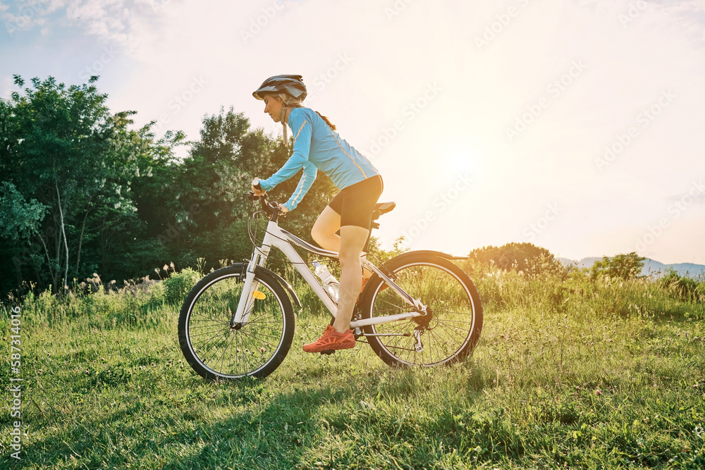 Cyclist Woman riding bike go in sports outdoors on sunny day a mountain in the forest. Silhouette female at sunset. Fresh air. Health care, authenticity, sense of balance and calmness.
Cyclist Woman riding bike go in sports outdoors on sunny day a mountain in the forest. Silhouette female at sunset. Fresh air. Health care, authenticity, sense of balance and calmness.