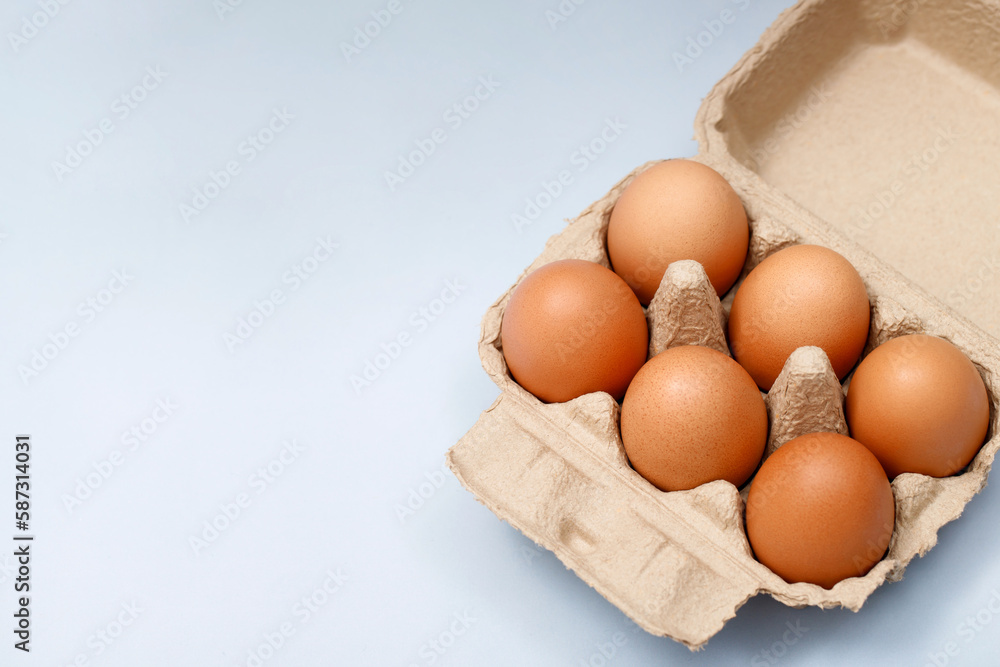 Chicken eggs in a cardboard box ready to cook on the table in the kitchen Chicken eggs in a cardboard box ready to cook on the table in the kitchen
