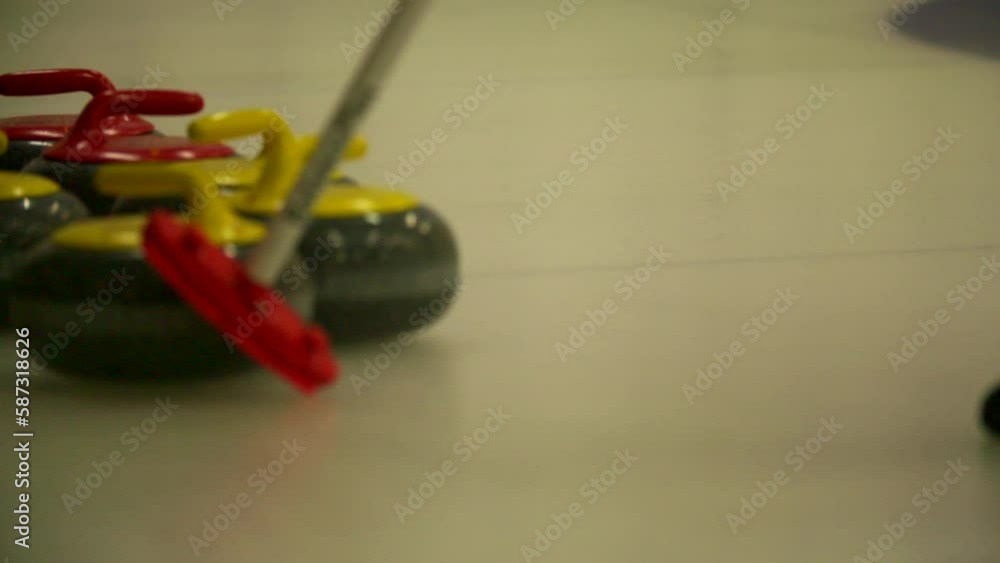 Slow Motion Shot Of Player Playing With Curling Stone And Broom On Ice Rink In Stadium - Los Angeles, California Slow Motion Shot Of Player Playing With Curling Stone And Broom On Ice Rink In Stadium - Los Angeles, California