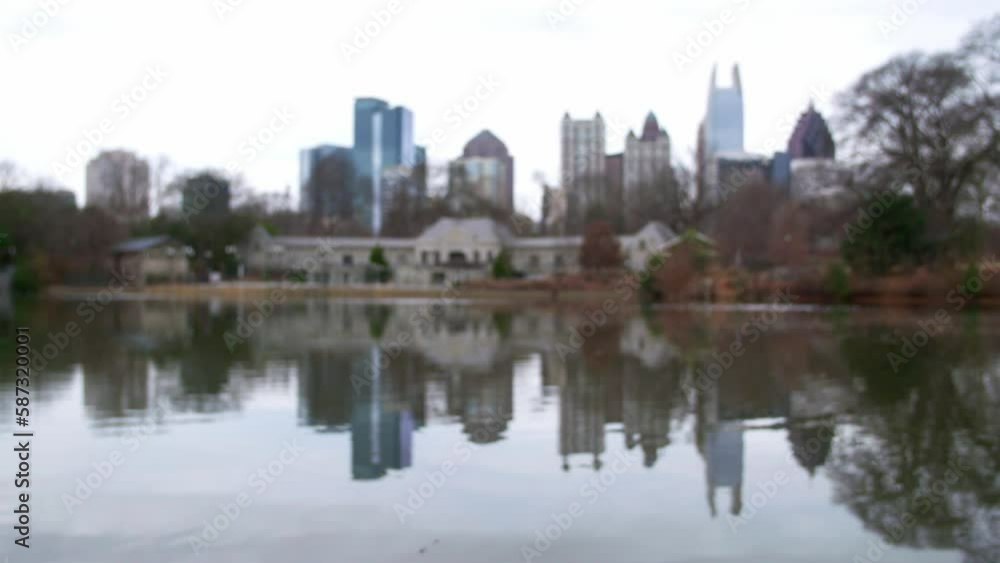 Slow Motion Lockdown Shot Of Piedmont Park Aquatic Center By Lake Against Modern City - Atlanta, Georgia Slow Motion Lockdown Shot Of Piedmont Park Aquatic Center By Lake Against Modern City - Atlanta, Georgia