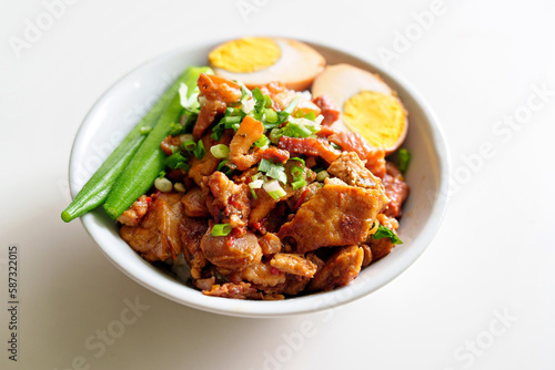 Braised meat rice, close up of stewed pork over cooked rice, egg and lady finger. Taiwanese traditional cuisine food.