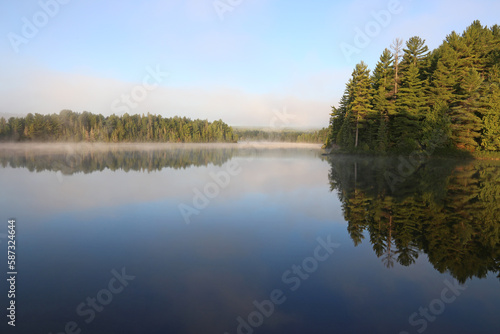 A misty morning on Sunbeam Lake in Algonquin Provincial Park, Ontario, Canada..